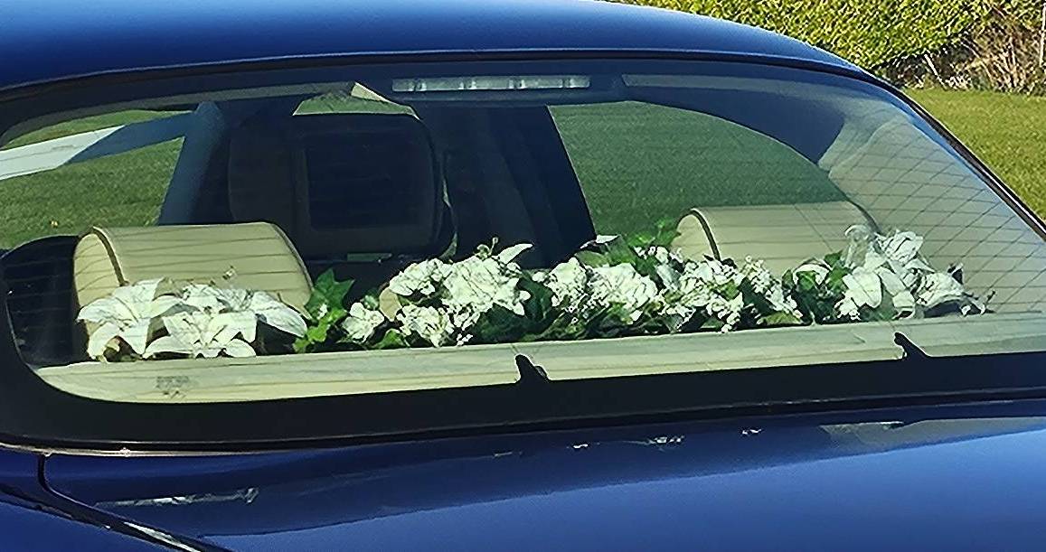 Flowers in car rear window